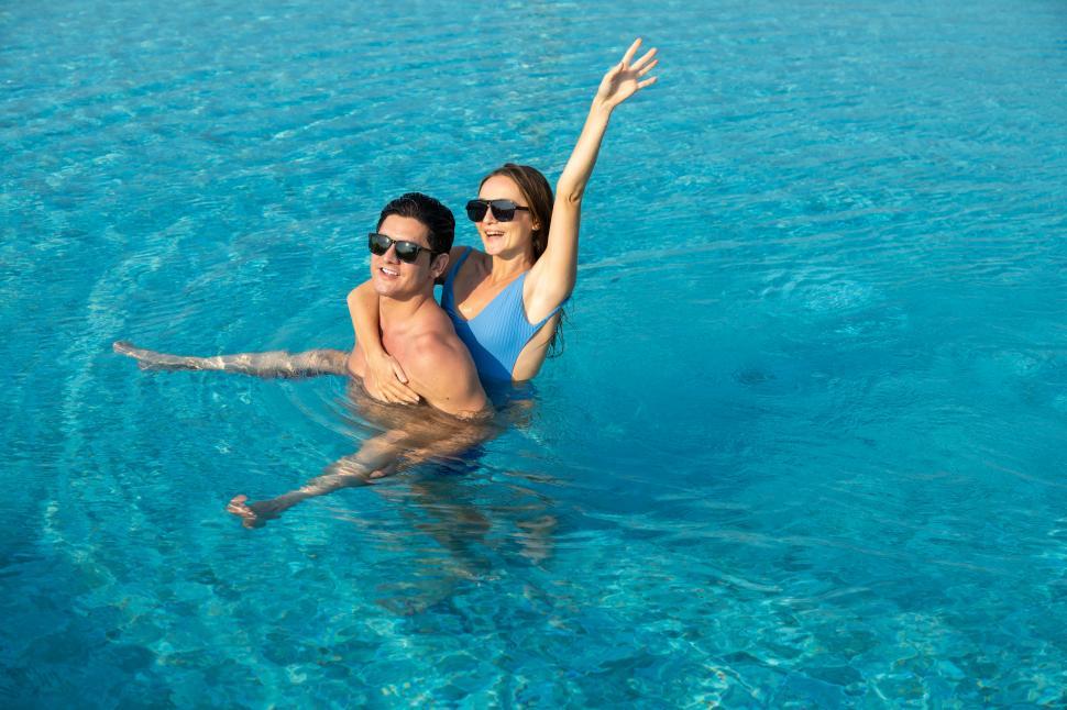 Free Image of piggyback ride in the pool 