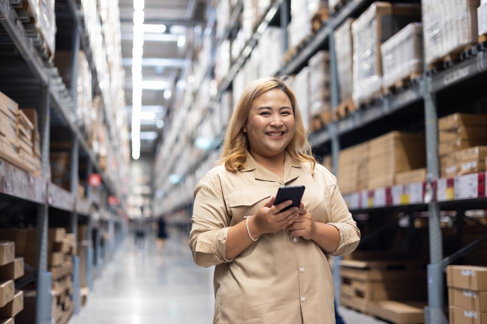 Free Stock Photo of Female warehouse worker inspecting products
