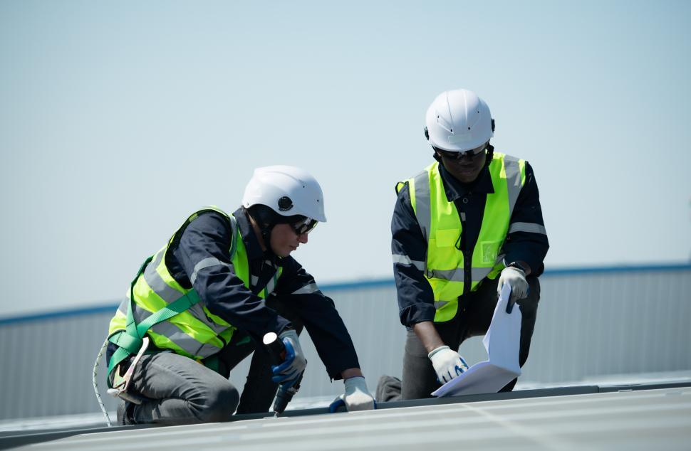 Free Stock Photo of Engineers in charge of solar panel installation