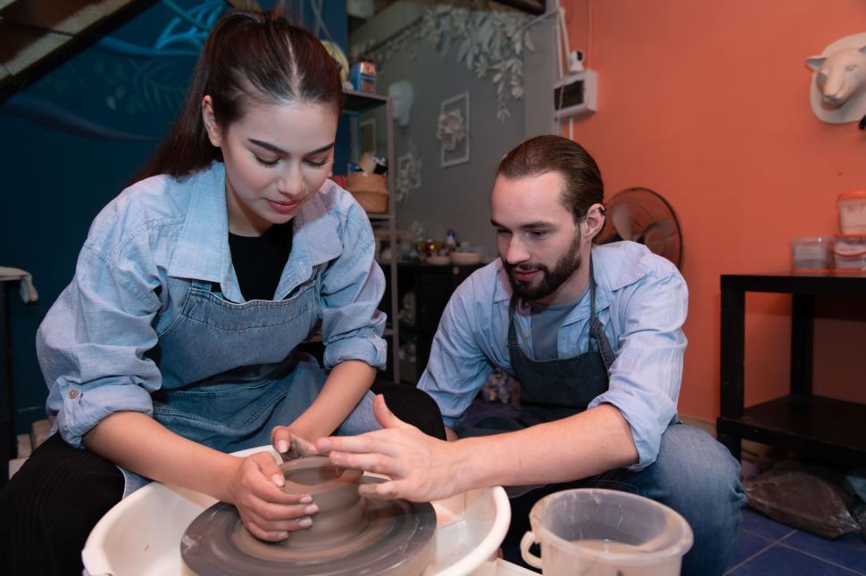 Free Stock Photo of Young couples making pottery together Download