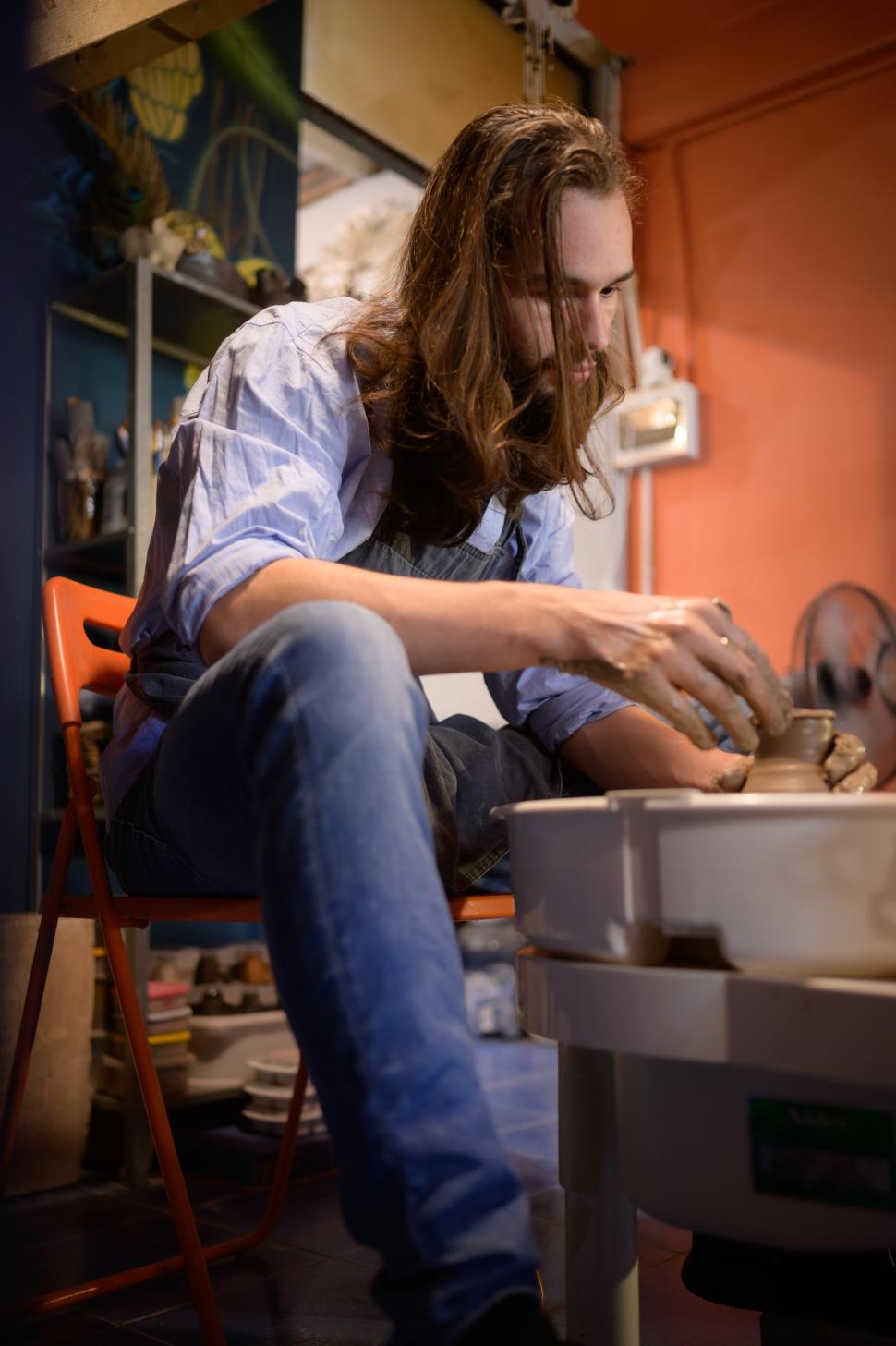 Free Stock Photo of Pottery artist throwing pot on a wheel Download