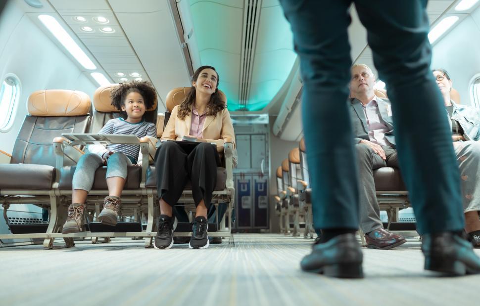 Free Image of Flight attendants show how to use safety devices and recommend emergency exits 