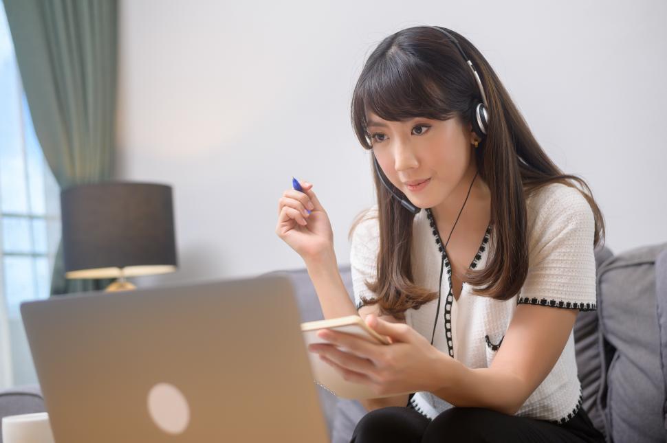 Free Image of Beautiful young woman wearing headset is making video conference call 