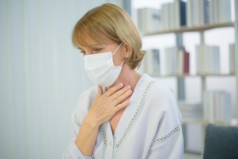 Free Image of Senior caucasian woman wearing a mask feeling sick 