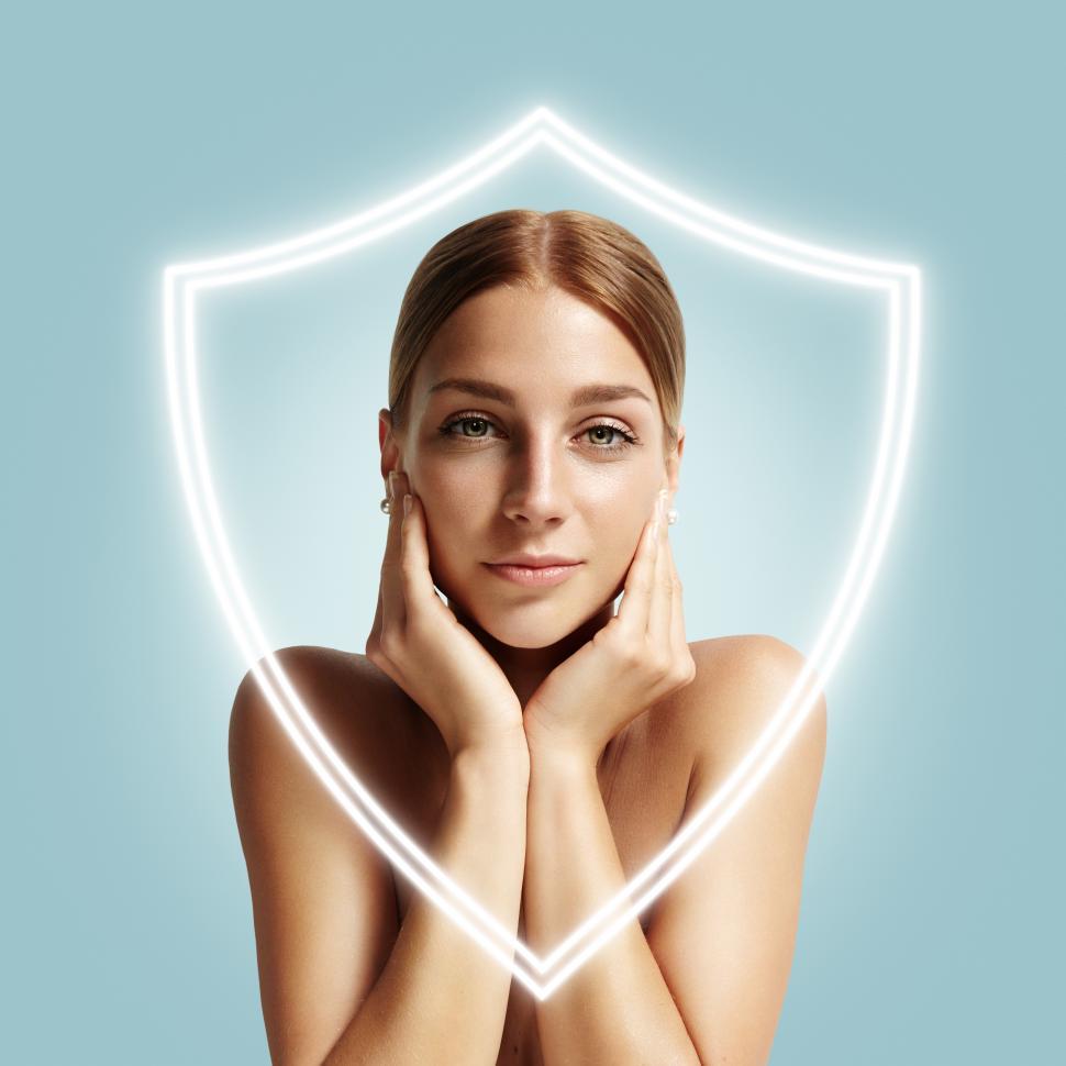 Free Image of Pretty woman behind a shield which protects her skin 