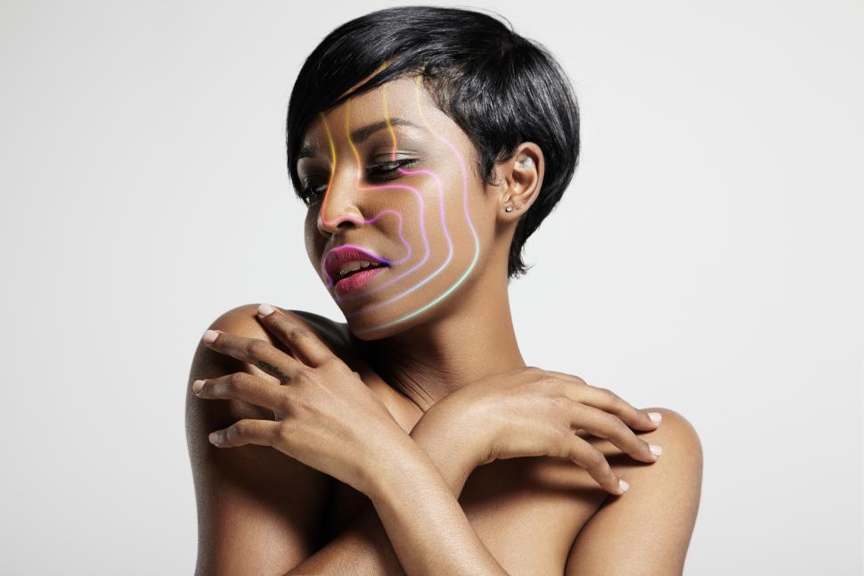 Free Image of pretty woman with contoured rainbow colored lines on her face 