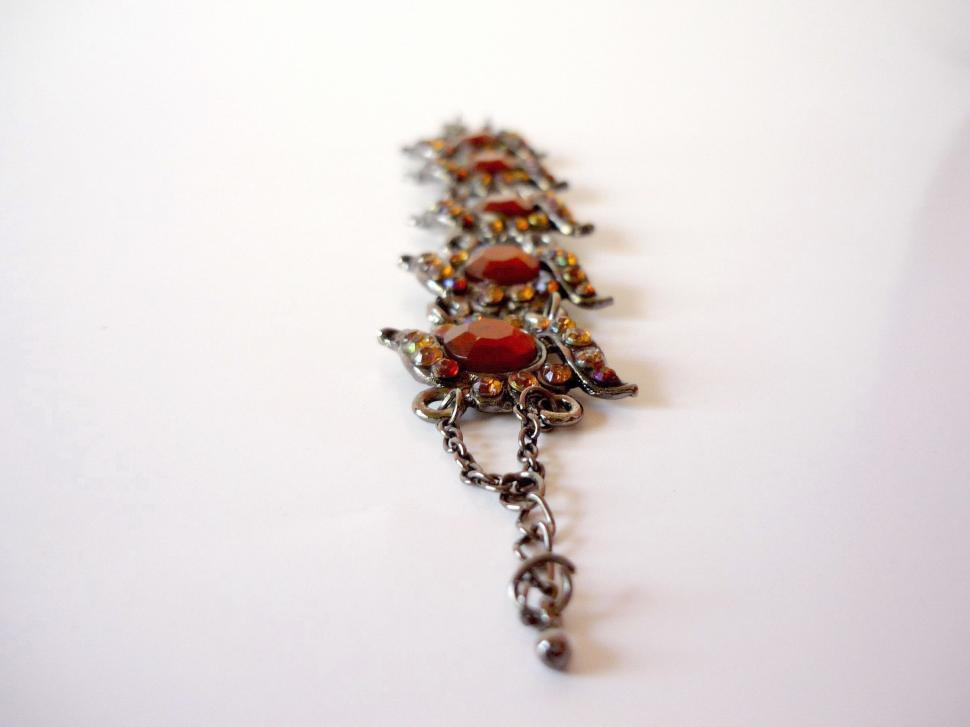 Free Image of Close Up of Chain With Red Stone 