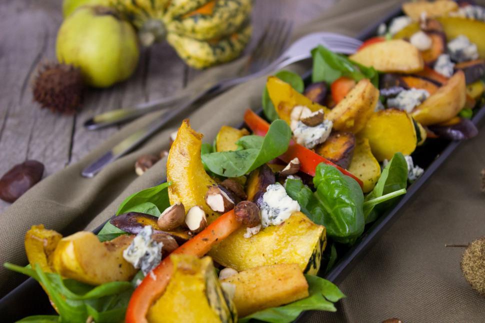 Free Image of A plate of salad with vegetables and nuts 