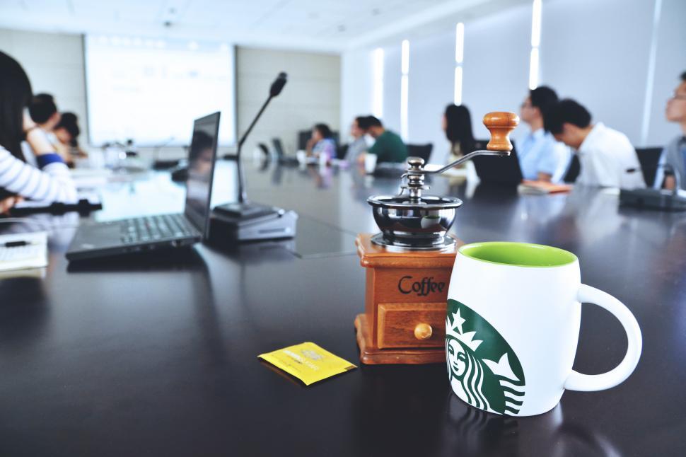 Free Image of A coffee grinder and a mug on a table 