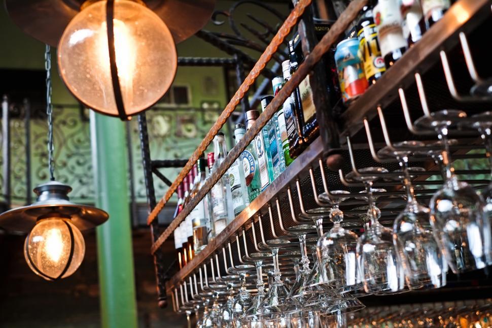 Free Image of A bar with wine glasses and bottles 