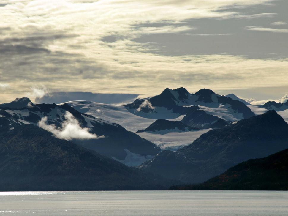 Free Image of A snowy mountains and a body of water 
