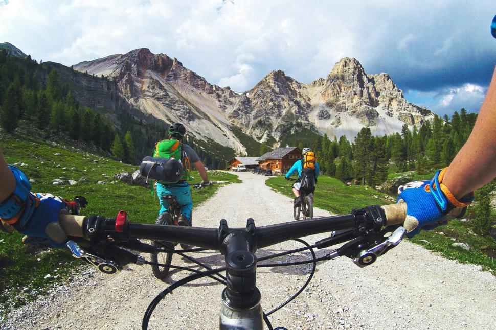 Free Stock Photo of A group of people riding bikes on a dirt road ...