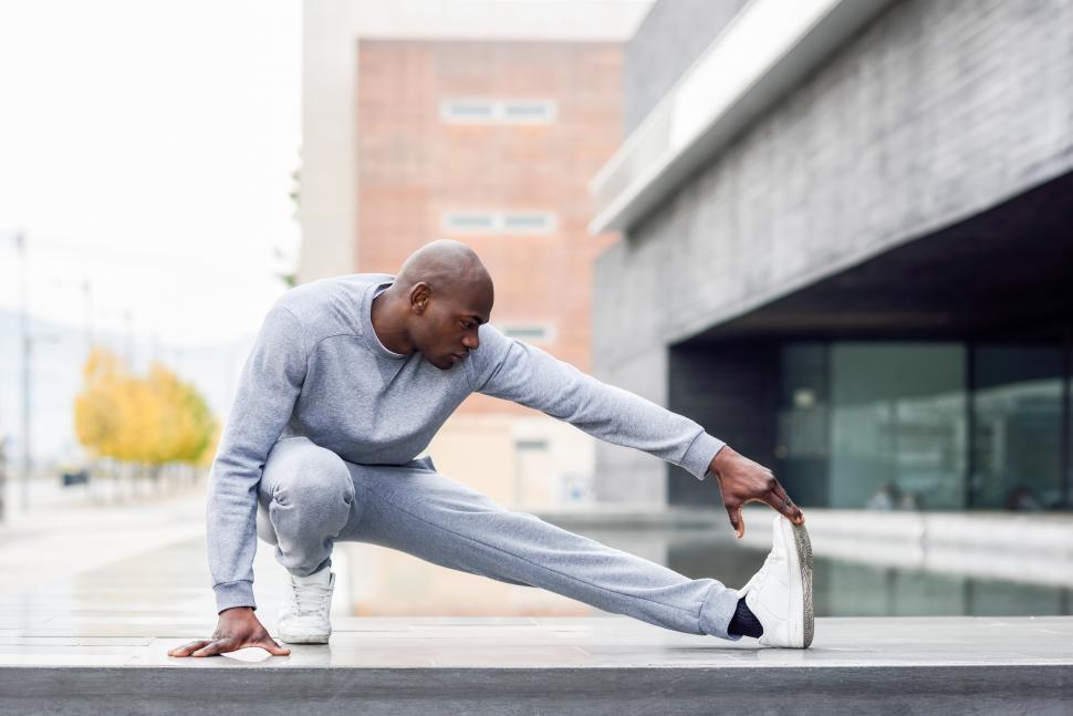 Free Stock Photo of Black man doing stretching before running in urban ...