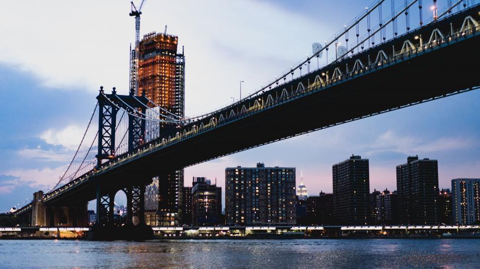 Free Image of A bridge over water with a city in the background 