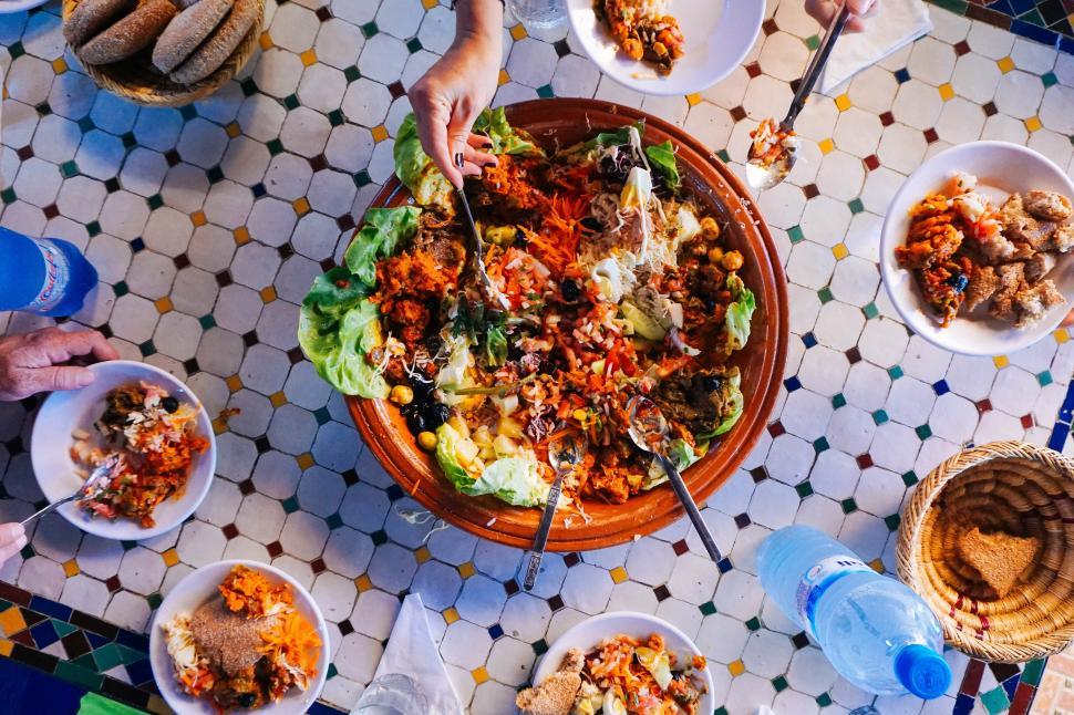 Free Image of A bowl of food with a person holding a fork 