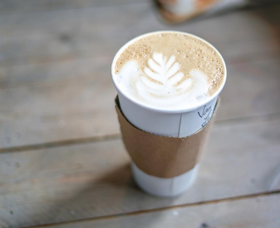 Free Image of A cup of coffee with a leaf design on top 