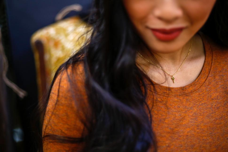 Free Image of A close up of a woman s neck 