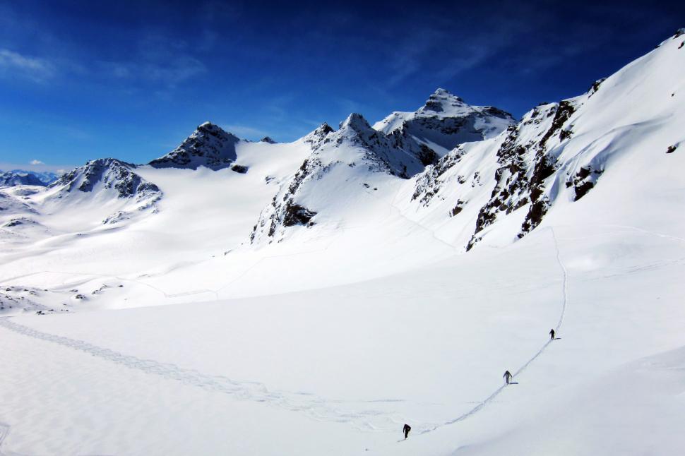 Free Image of A group of people hiking in the snow 