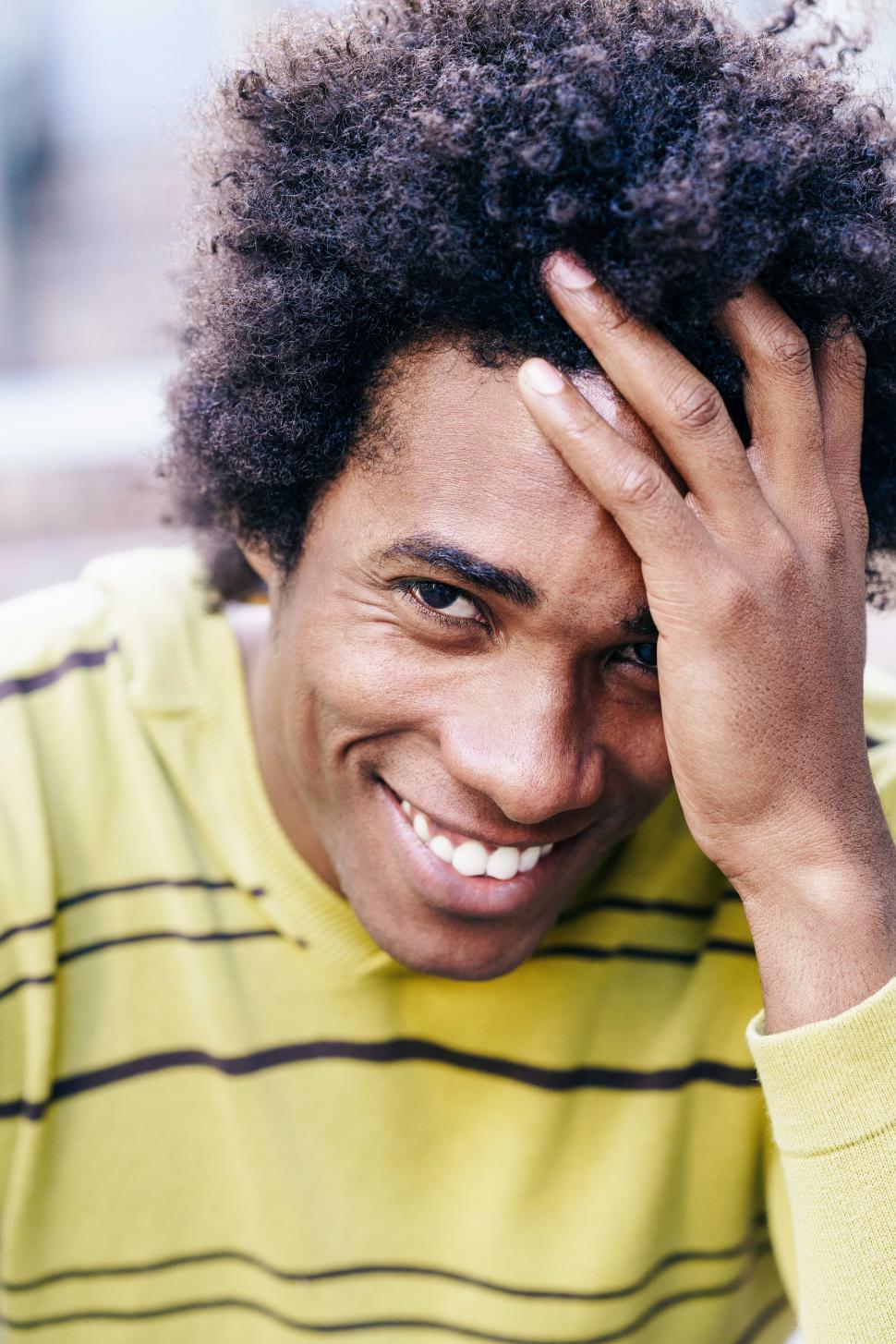 Free Image of Cuban black tourist with afro hair sitting on the floor 