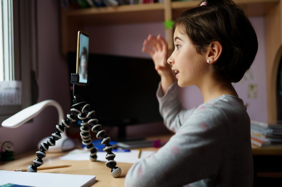Free Image of Little girls talking via video conference with smartphone 