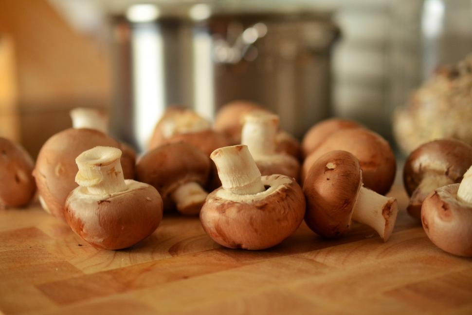 Free Image of A group of mushrooms on a wooden surface 