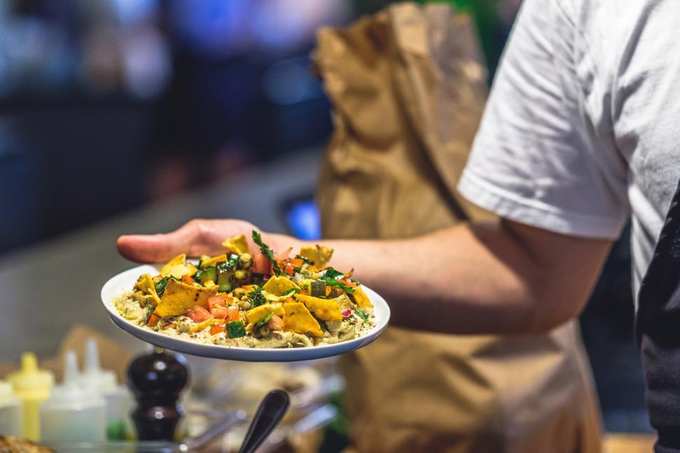 Free Image of A person holding a plate of food 