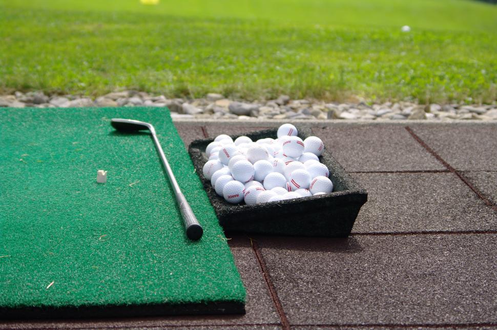 Golf Ball and Golf Club on Green Mat