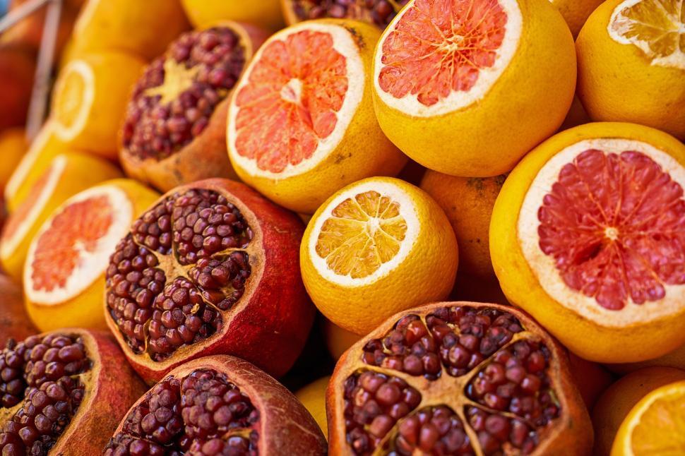 Free Image of A group of oranges and pomegranates 