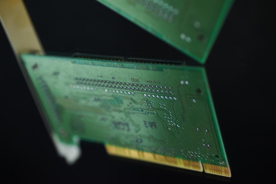 Free Image of A green circuit board with gold edges 