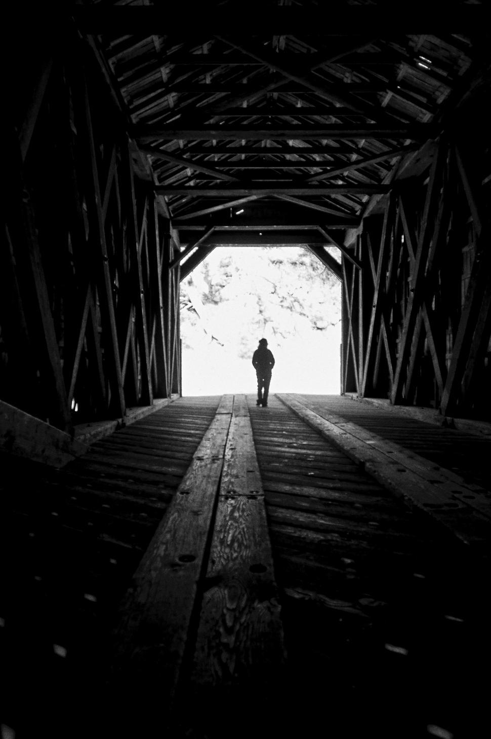 Free Image of A person walking in a tunnel 