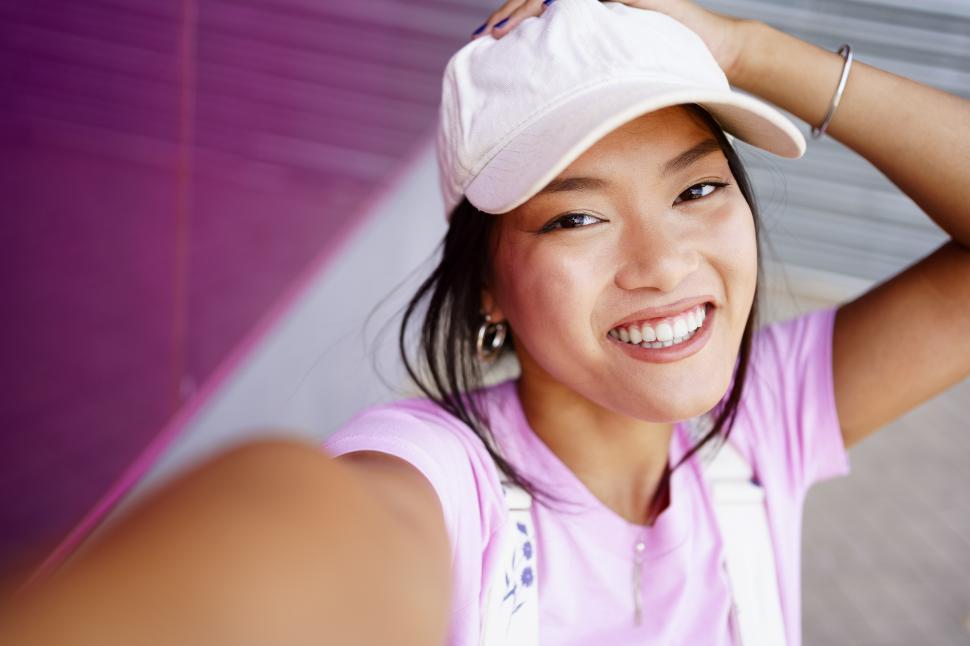 glad-asian-female-taking-selfie.jpg