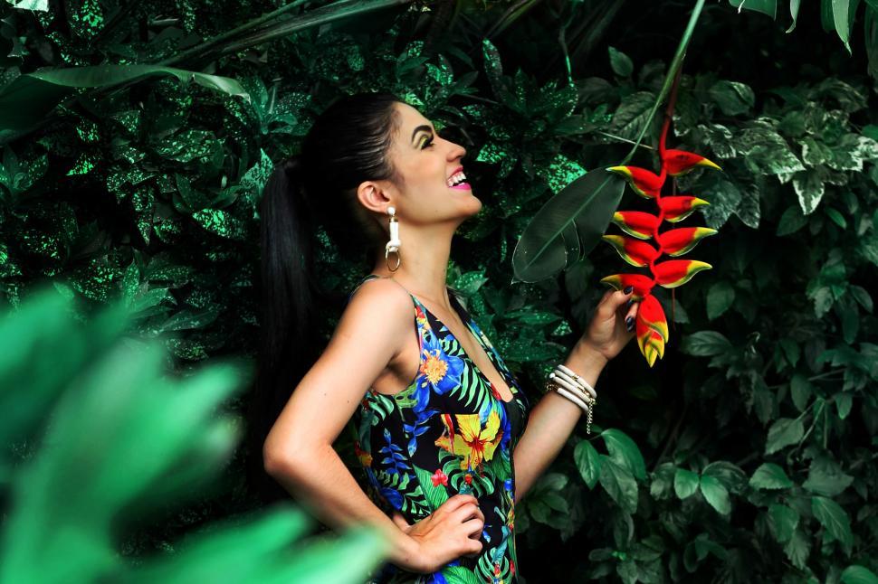 Free Image of A woman holding a flower 