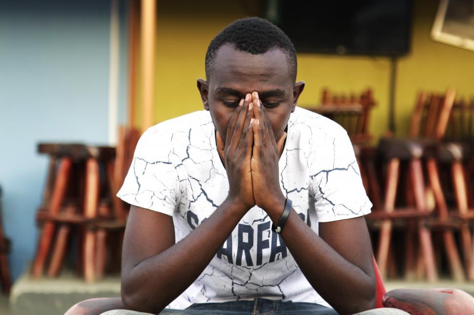 Free Image of A man with his hands in his face 
