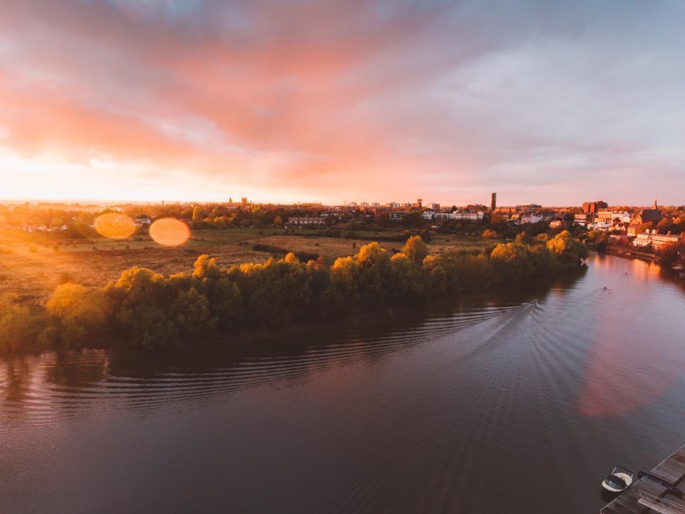 Free Image of A river with trees and a city in the background 