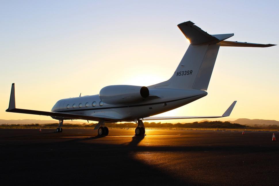 Free Image of A white airplane on a runway 