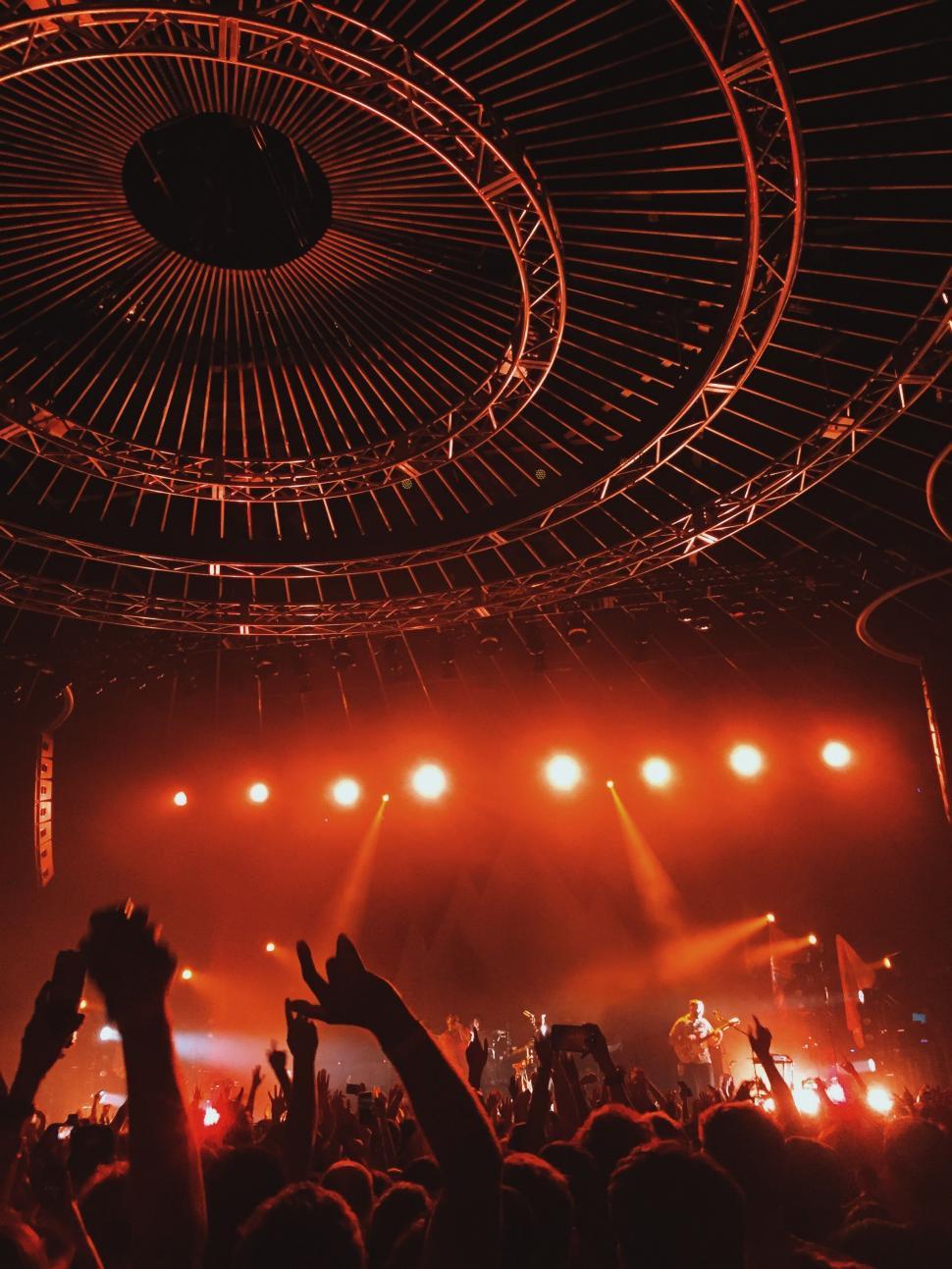 Free Image of A crowd of people on a stage with lights 