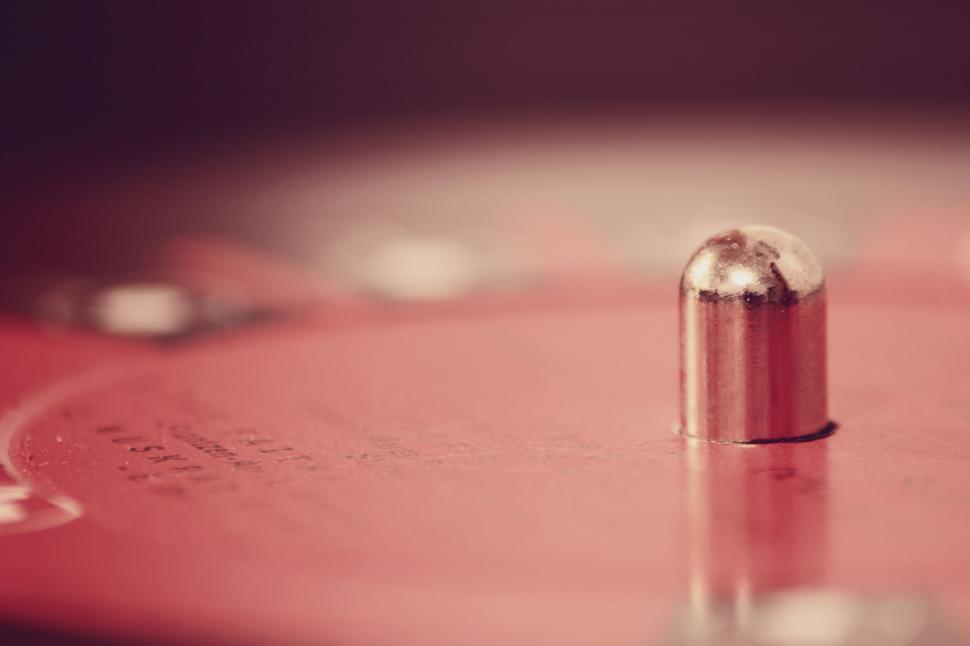 Free Image of A metal object on a red surface 