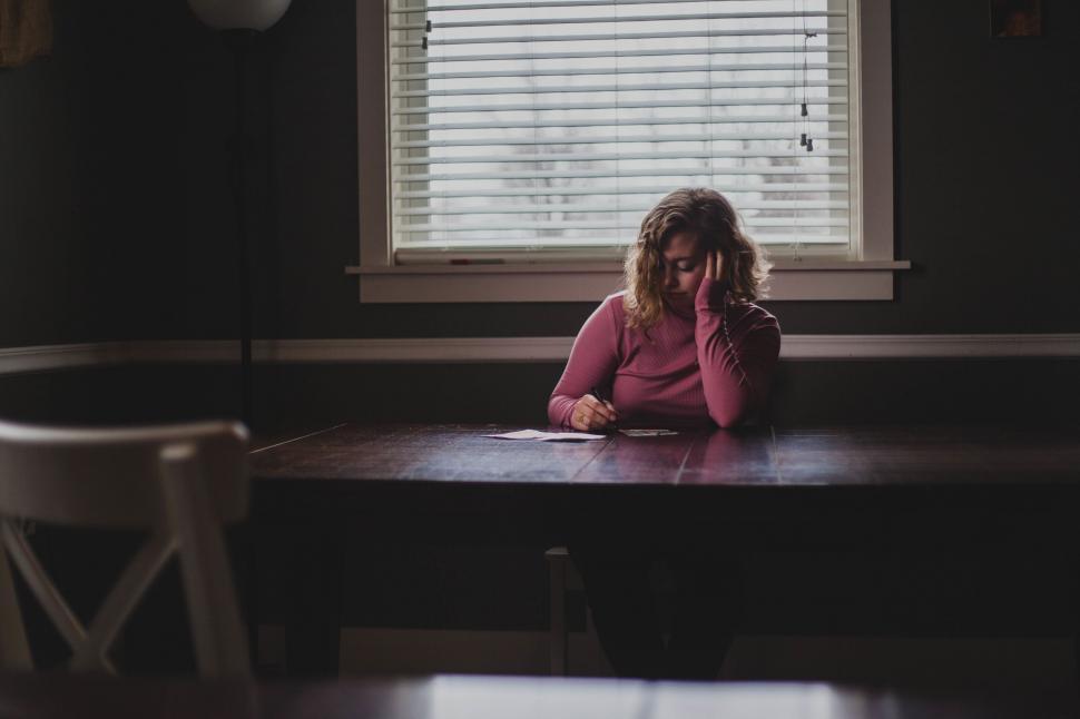 Free Image of A woman sitting at a table 