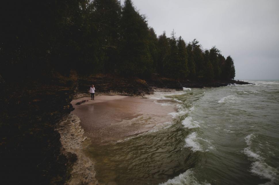 Free Image of A person standing on a beach 