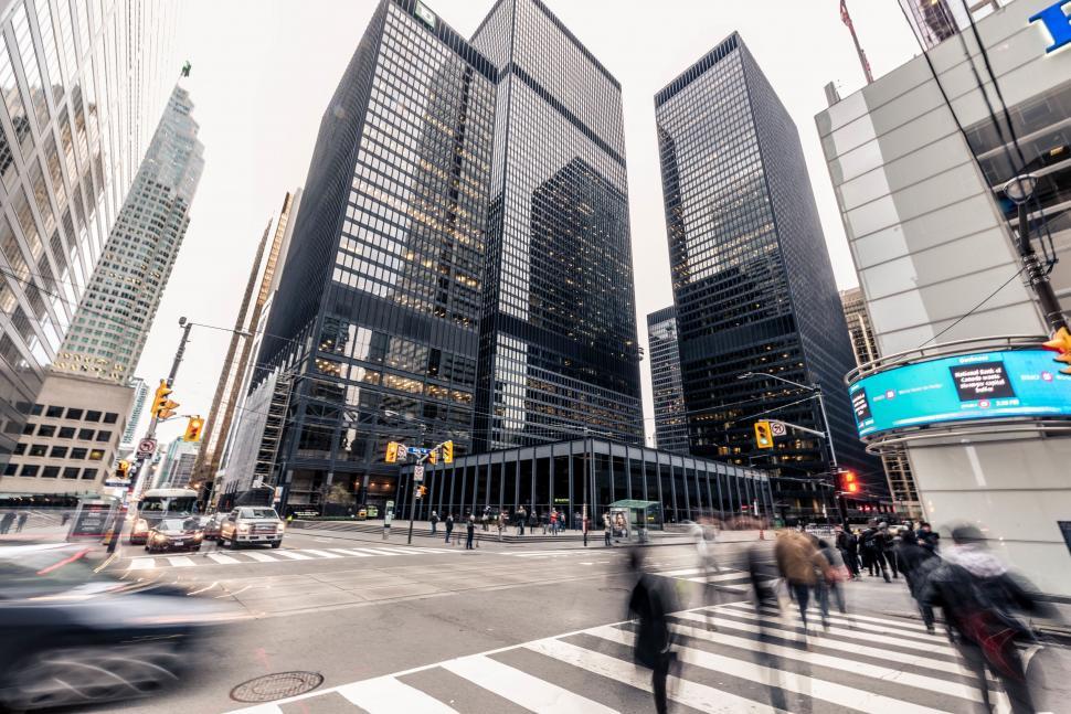 Free Image of A group of people crossing a street in a city 