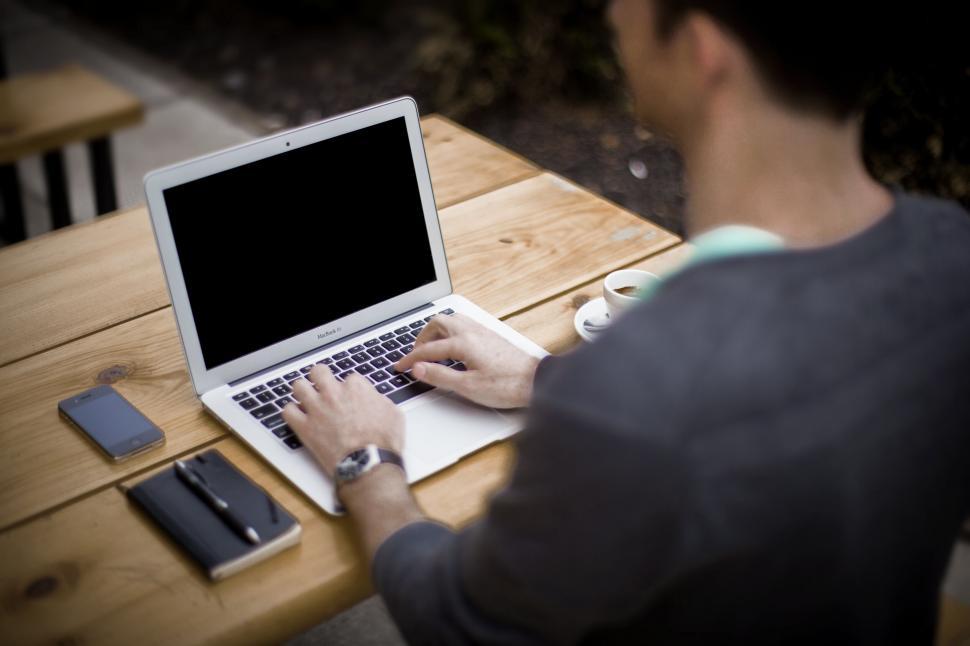 Free Image of A man typing on a laptop 