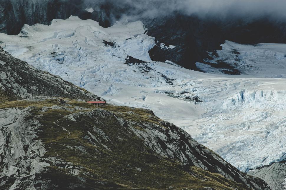 Free Image of A snowy mountain with a building on the side 