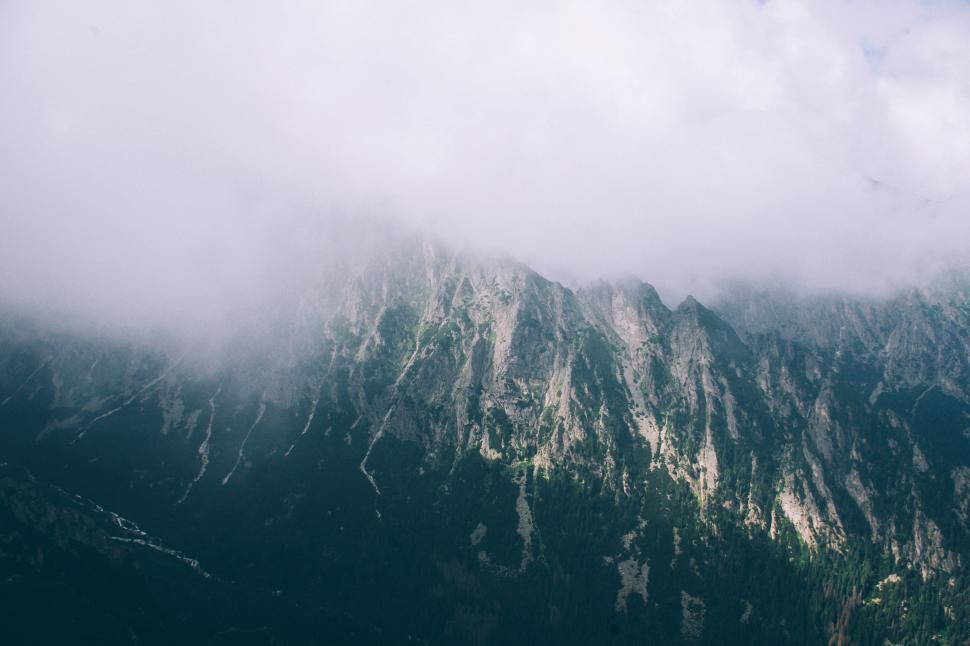Free Image of A mountain with clouds in the sky 