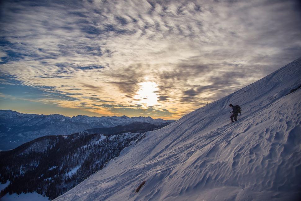Free Image of A person climbing a snowy mountain 