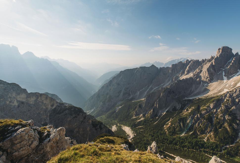 Free Image of A mountain range with trees and a valley 