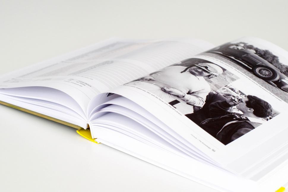 Free Image of An open book with a yellow bookmark 