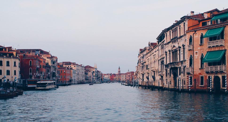 Free Image of A water way with buildings and boats with grand canal in the background 