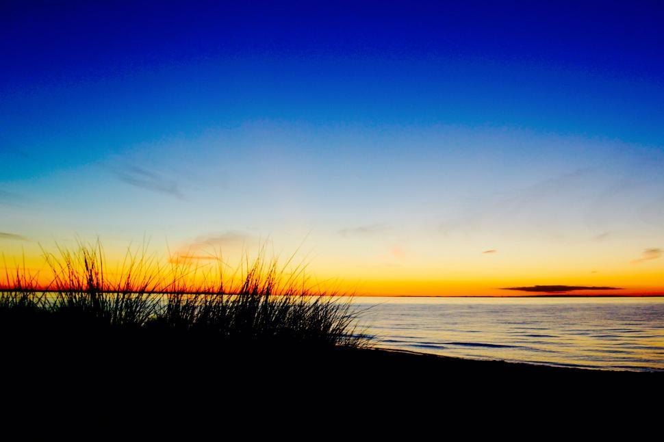 Free Image of A sunset over a beach 
