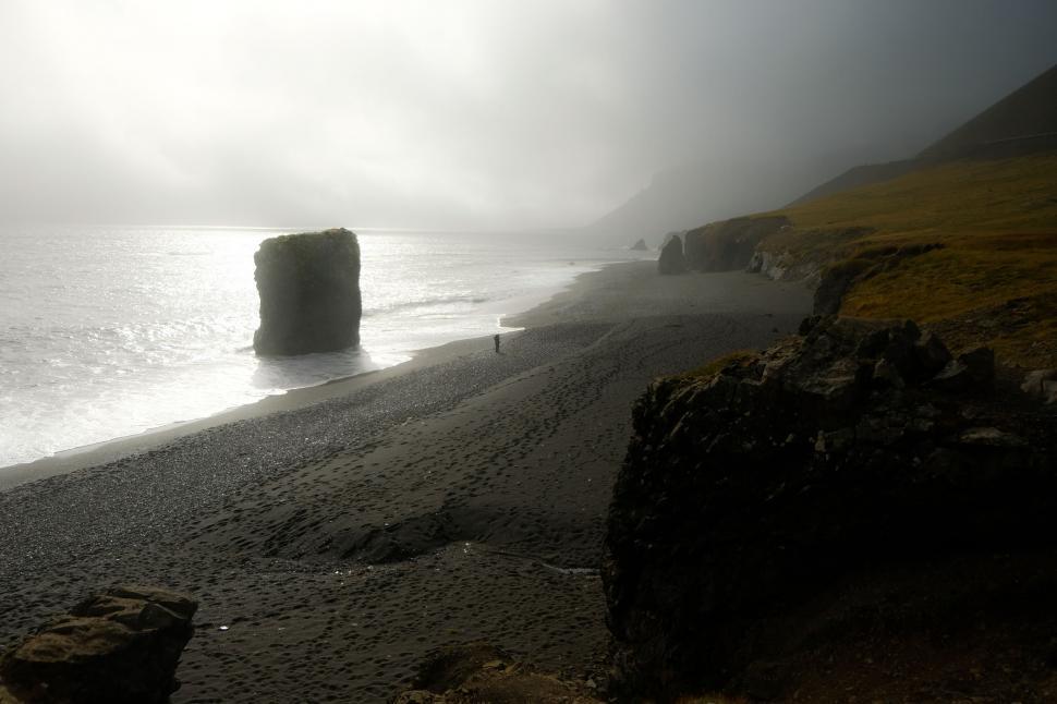 Free Image of A person walking on a beach 