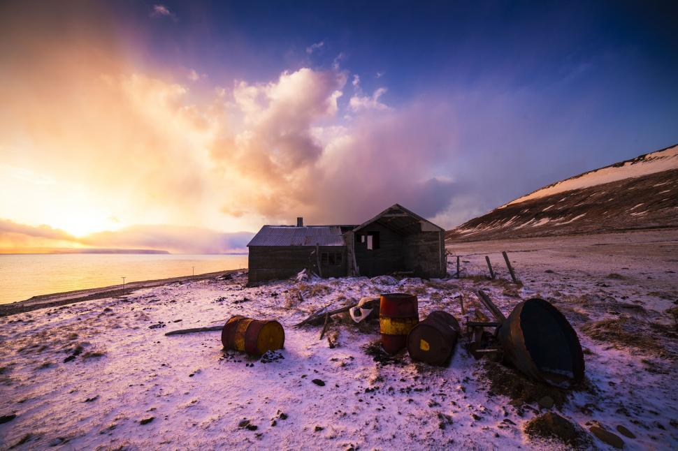 Free Image of A house with barrels on the snow 
